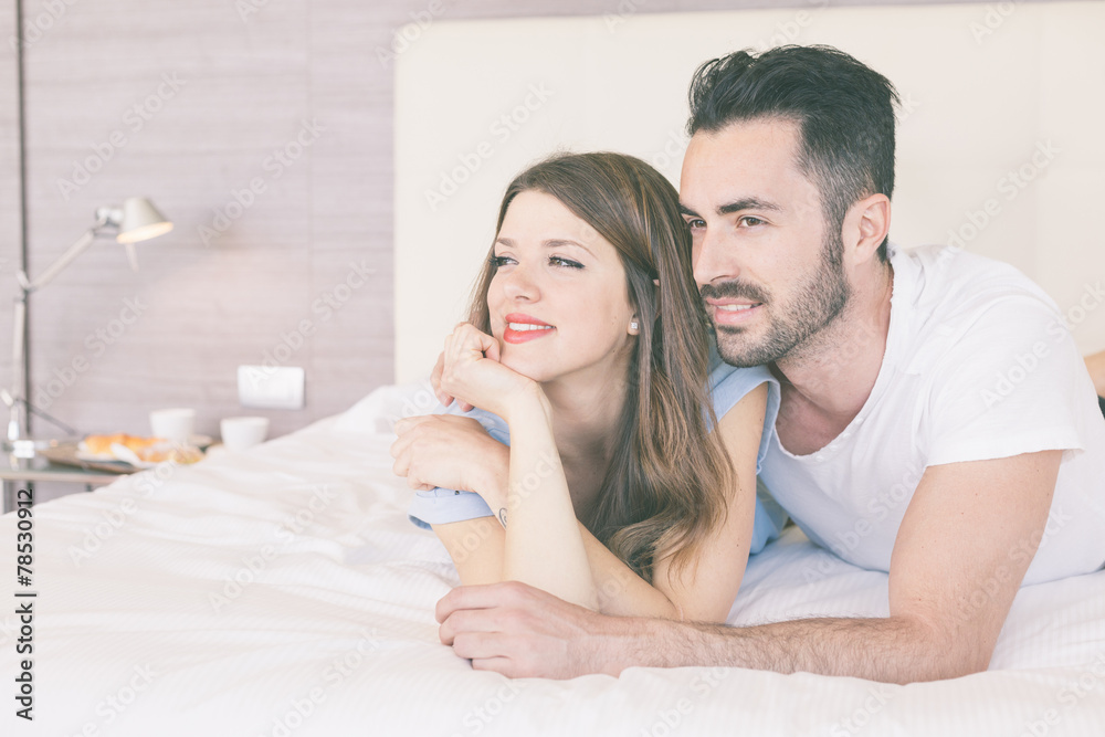 Young couple embraced on the bed