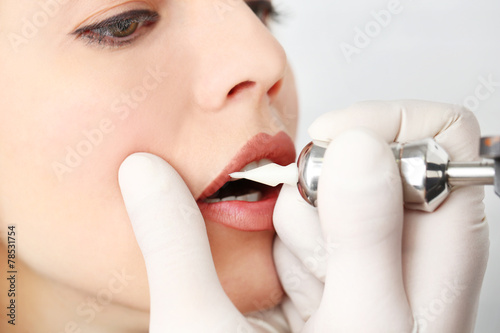 Cosmetologist making perman...