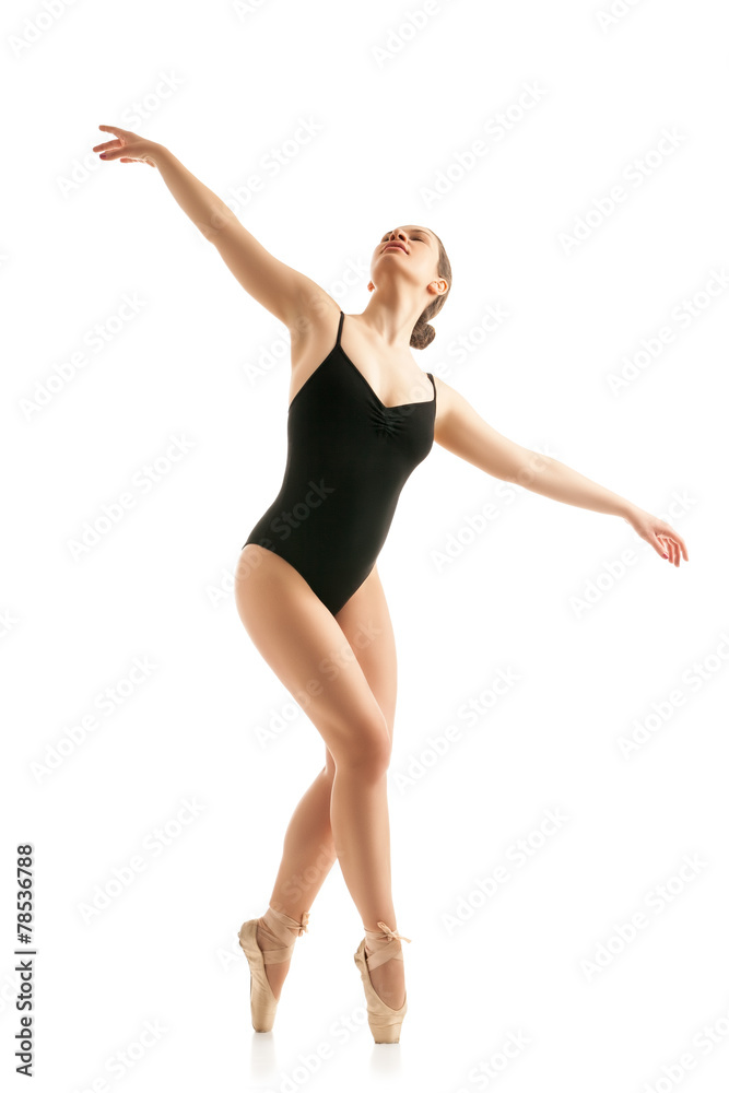 young beautiful dancer posing on studio background