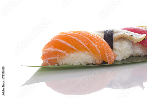 Sushi on a bamboo list over white background