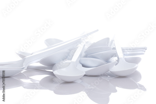 white plastic spoons isolated on white background photo