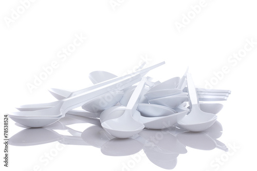 white plastic spoons isolated on white background