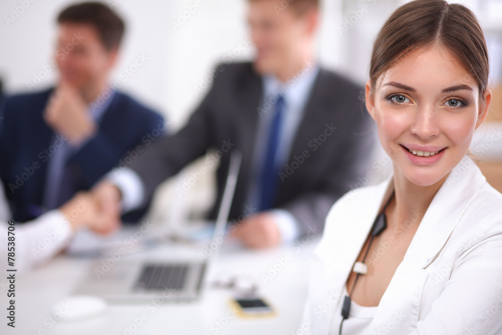 Business people sitting and discussing at business meeting Business people sitting and discussing at business meeting