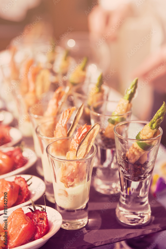 Glasses with seafood snacks, toned image Glasses with seafood snacks, toned image