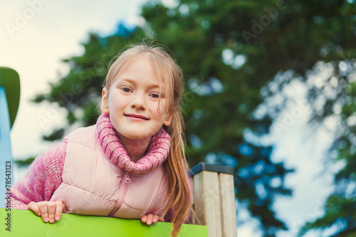 Outdoor portrait of a cute little girl on playground