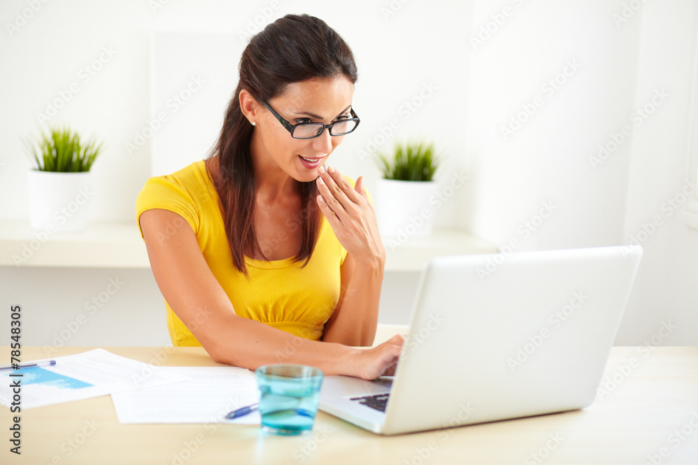 Female surprised secretary sitting in her office Female surprised secretary sitting in her office