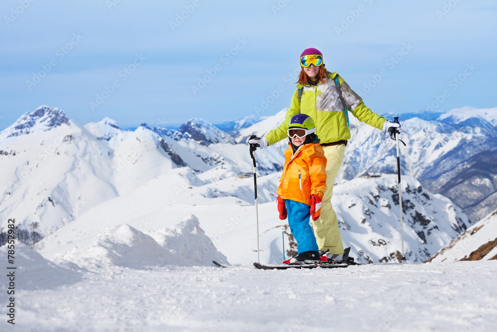 Mother with boy skiers in mountains