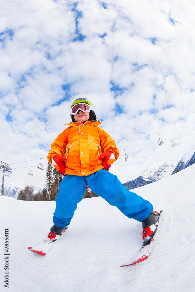 View from below of boy wearing ski mask and skiing