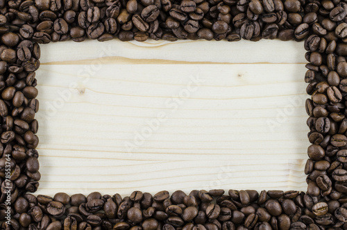 Frame of coffee beans on wooden table. Background