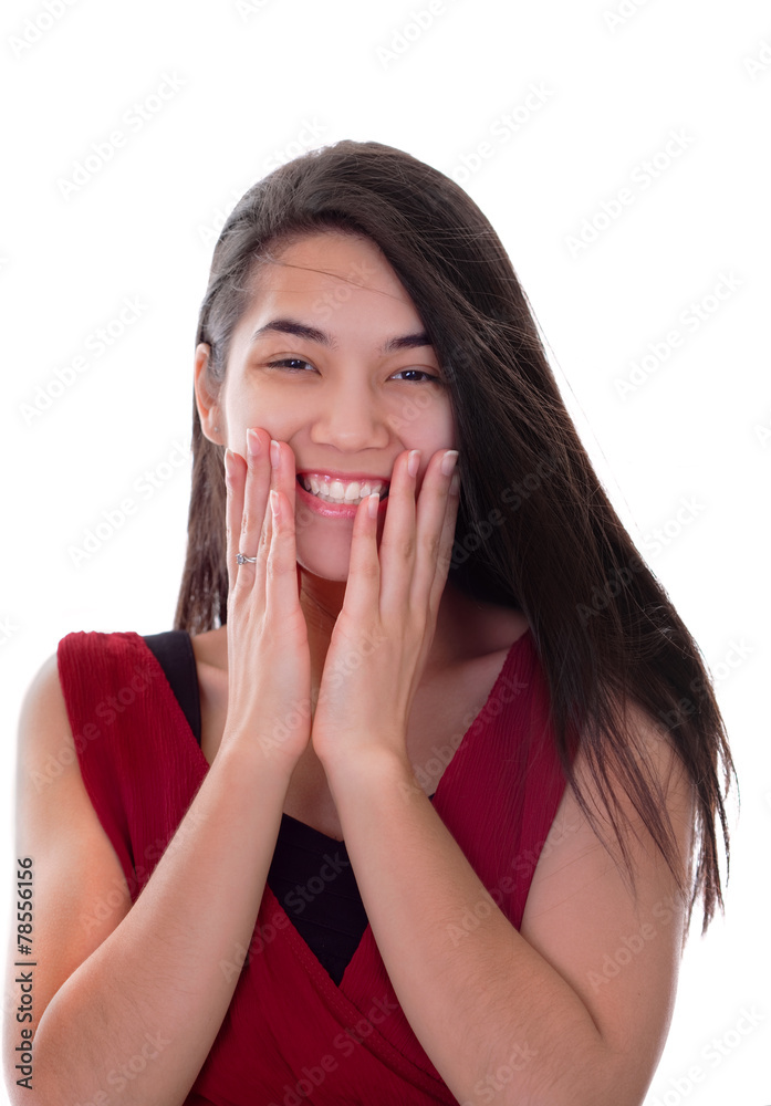 Beautiful biracial teen girl in red dress excited, hands on face Beautiful biracial teen girl in red dress excited, hands on face