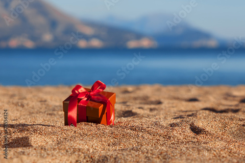 Terracotta color gift box ona beach