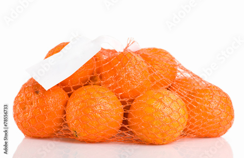 A bunch of oranges packaged in red netting, isolated on white