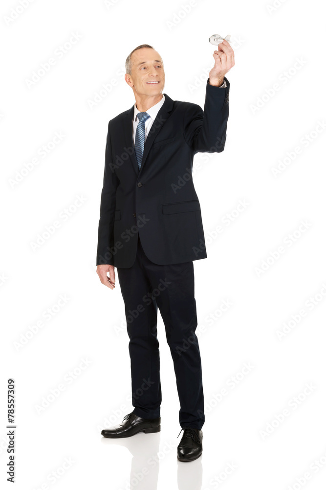 Full length businessman holding small airplane Full length businessman holding small airplane