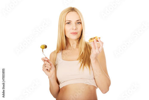 Happy pregnant woman with cake and pickles