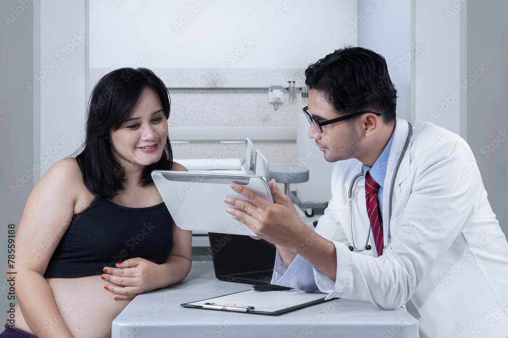 Doctor shows treatment result on digital tablet Doctor shows treatment result on digital tablet