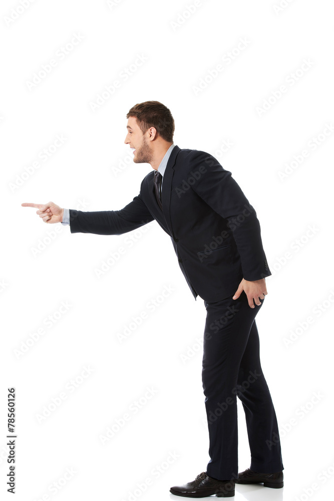 Angry businessman pointing to the left. Angry businessman pointing to the left.