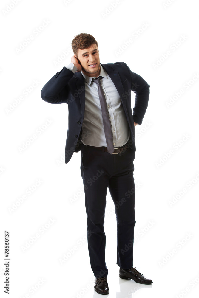 Annoyed businessman covering his ear. Annoyed businessman covering his ear.