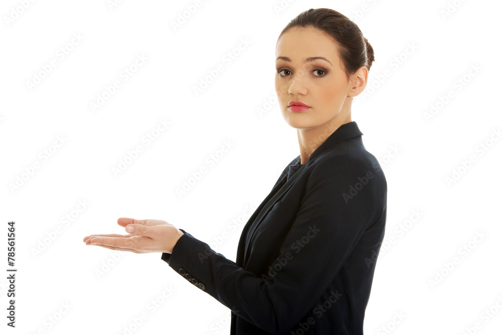 Young woman holding copy space in hands.