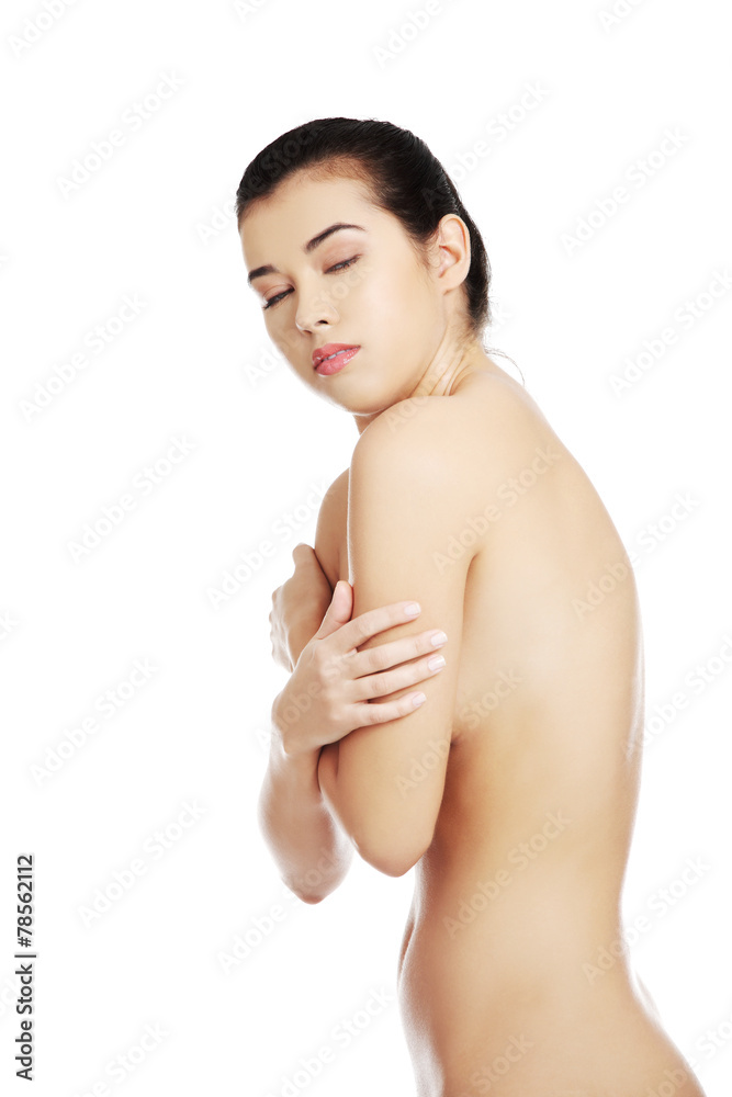 Side view of nude woman covering her breast Side view of nude woman covering her breast