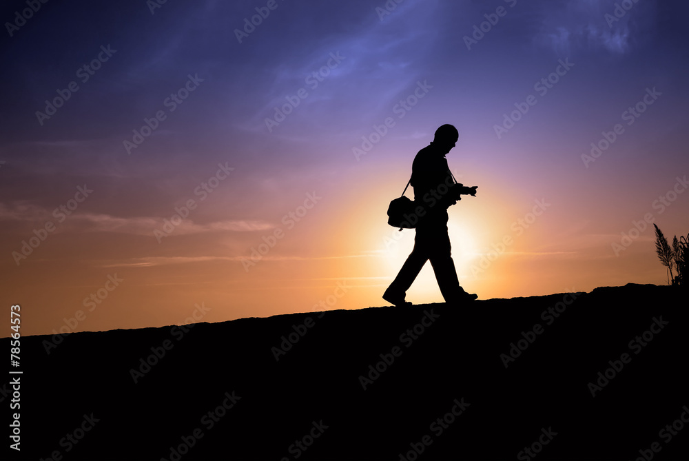 Silhouette of a man walking
