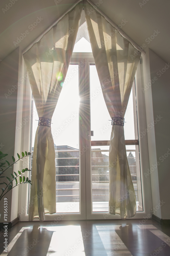 Balcony window with curtains in the morning