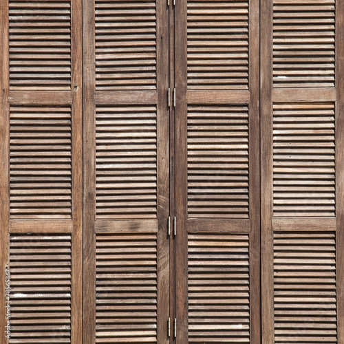 Background latticed wooden doors in the tropical house © OlegD