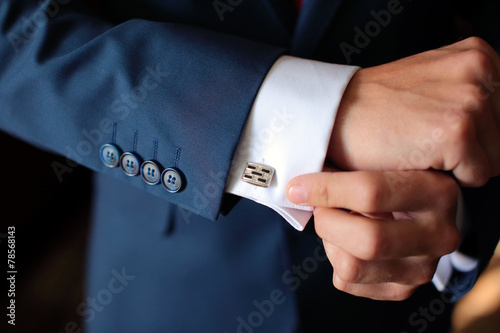 Hands of wedding groom getting ready in suit photo
