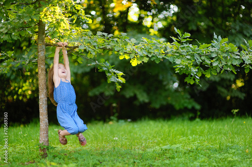 Cute little girl having fun in a park