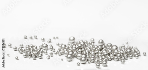 Pure silver granules on a white background