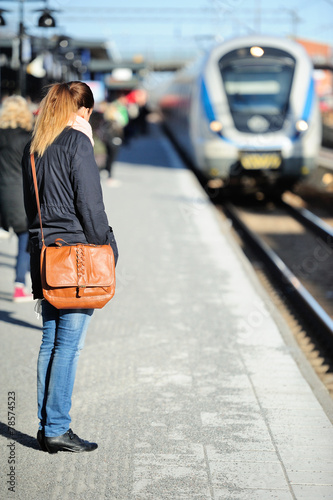 Woman waiting for incoming train