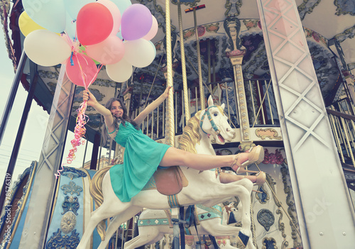 Canvas-taulu Merry-go-round young woman playing on carousel, toned.