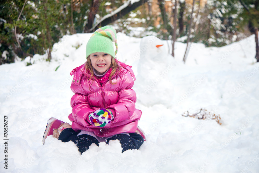 Cute blonde girl making snowball