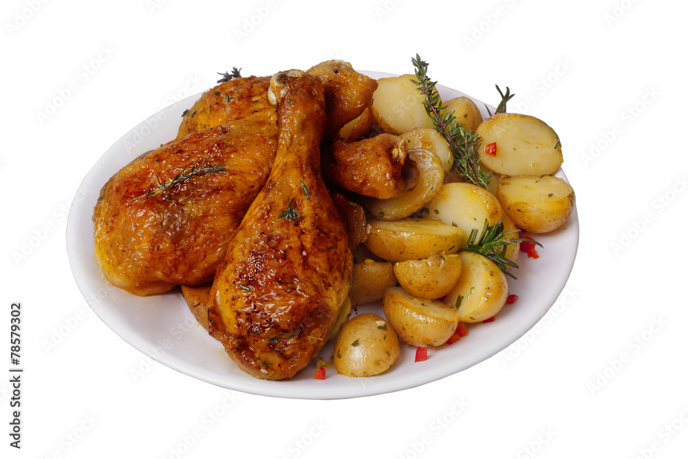 Fried chicken legs with potatoes, rosemary and thyme spices