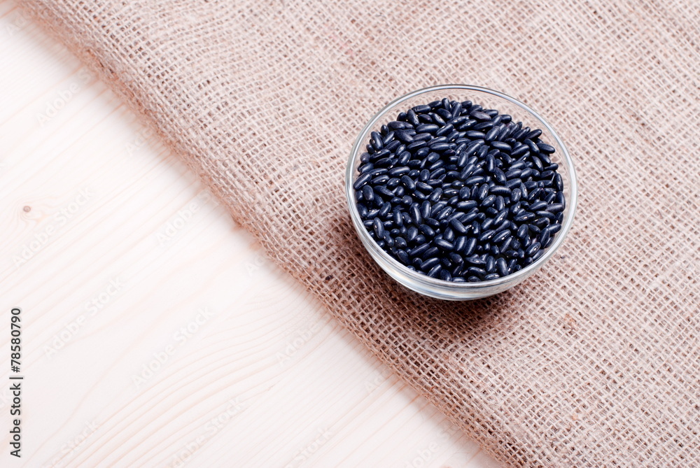 Fototapeta premium raw black beans on the board diet food