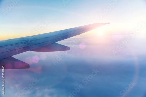 Wing of the plane on blue sky background