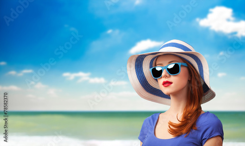 Redhead girl with sunglasses and hat