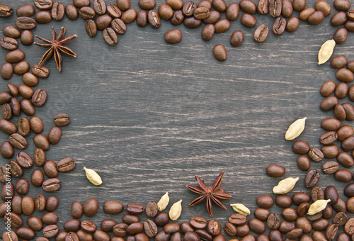 Coffee beans and some spices on wooden background