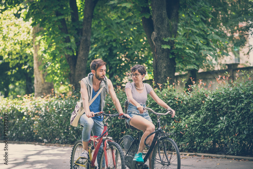 couple of friends young  man and woman riding bike © Eugenio Marongiu