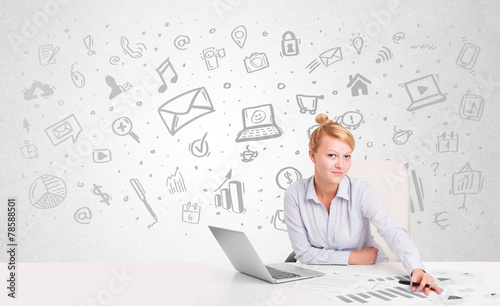 Business woman sitting at table with hand drawn media icons