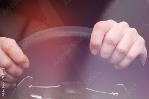 Woman s hands on steering wheel of a car
