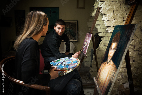 Two young painters  in the art studio photo