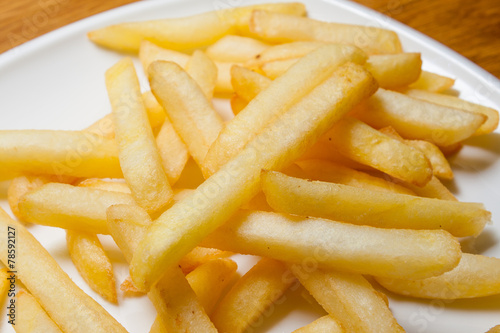 Tasty golden french fries on a plate