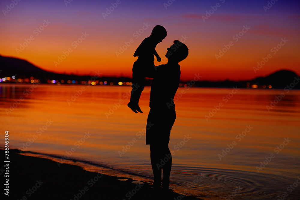 father and son enjoying life at sunset