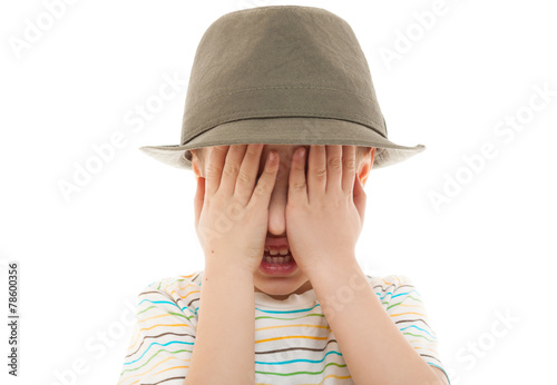 Fotografie child hide peek a boo hat retro portrait closeup