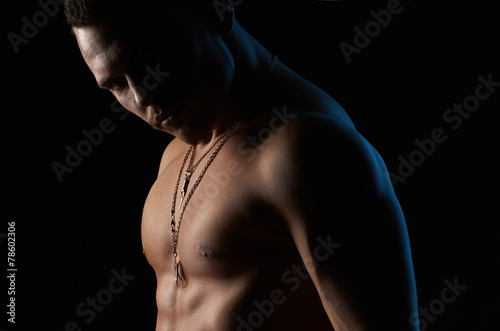 strong sexy man on black background