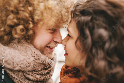 Young curly couple smiling at each other