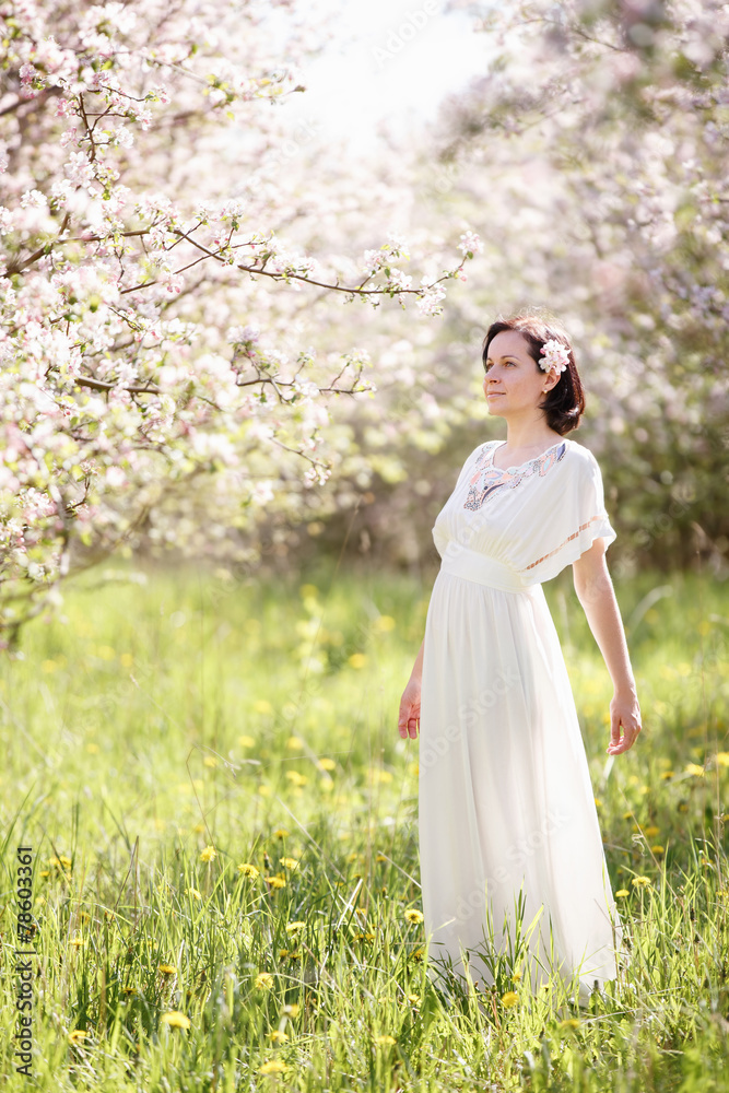 Beautiful young woman in apple blossom garden Beautiful young woman in apple blossom garden