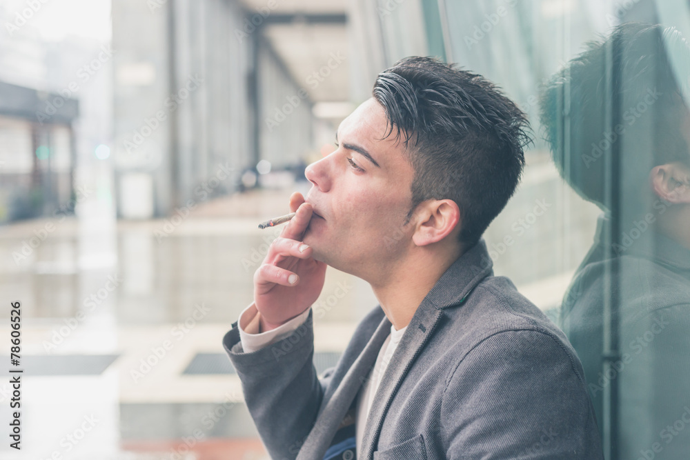 Young handsome man smoking a cigarette Young handsome man smoking a cigarette