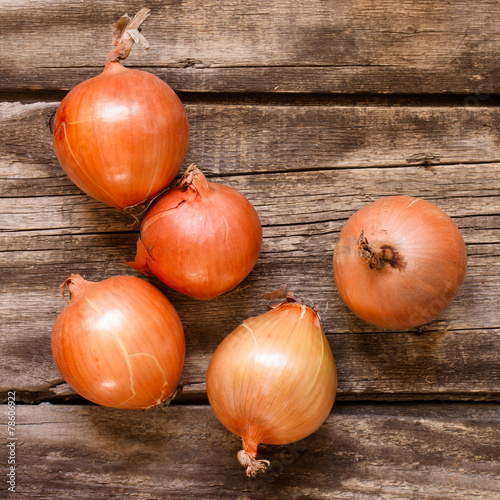 onions on vintage wood table background - rustic style