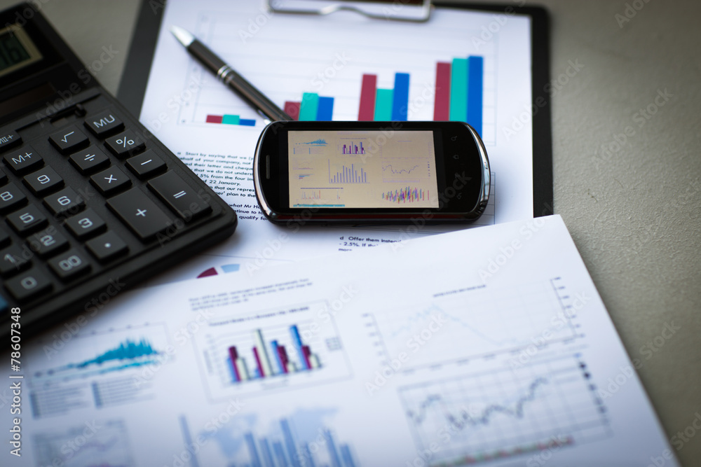 Business chart with smart phone and pen Business chart with smart phone and pen